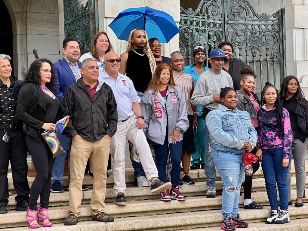 Guests and speakers at the Pride Month celebration gathered on the steps of Trenton City Hall